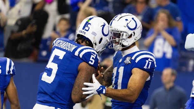 Sep 10, 2023; Indianapolis, Indiana, USA; Indianapolis Colts wide receiver Michael Pittman Jr. (11) gives his touchdown ball to quarterback Anthony Richardson (5) after scoring his first passing touchdown in the second half against the Jacksonville Jaguars at Lucas Oil Stadium.